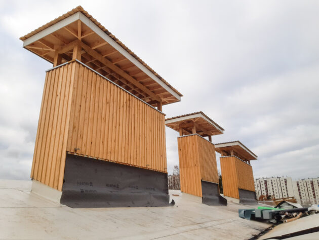 Installation des cheminées de ventilation naturelle préalablement assemblée au sol // DRI - ville de Rosny-sous-Bois / Topophile